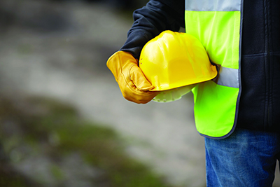 Worker holding hard hat